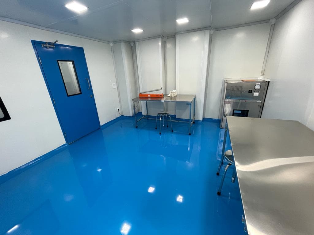 Clean room with blue epoxy floor and stainless steel tables